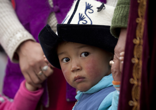 Young Boy With Kalpak Hat Holding His Mother Hand,  Saralasaz Jailoo, Kyrgyzstan