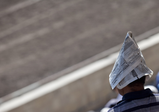 Man Using A Newspaper As An Improvised Hat To Protect From The Sun During The Horse Game On National Day, Bishkek, Kyrgyzstan