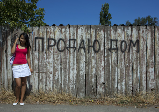 Beautiful Student Girl Posing In Front Of A House For Sale, Bishkek, Kyrgyzstan