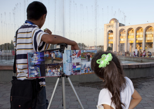 Girl Watching An Exhibition Of Pictures On A Square Of Bishkek, Kyrgyzstan