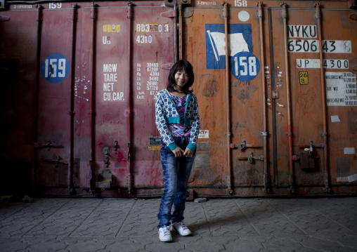 Girl In Front Of A Container In A Dordoi Market, Bishkek, Kyrgyzstan