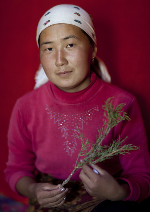 Woman With Headscarf Showing An Aromatic Herb, Jaman Echki Jailoo Village, Kyrgyzstan