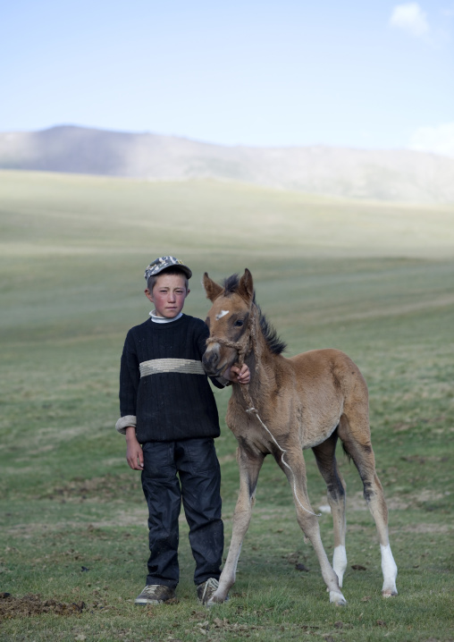 Boy Holding A Colt By The Bridle, Jaman Echki Jailoo Village, Song Kol Lake Area, Kyrgyzstan