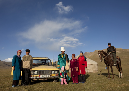 Family Gathered In Front Of Their Yurt And Car, Jaman Echki Jailoo Village, Song Kol Lake Area, Kyrgyzstan