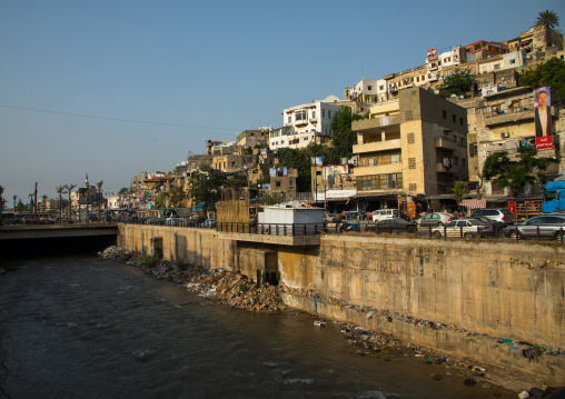 Polluted river crossing residential apartments and housing, North Governorate, Tripoli, Lebanon