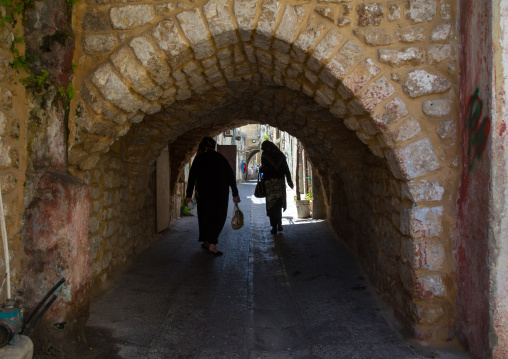Women passing thru an arch in the old town, South Governorate, Tyre, Lebanon