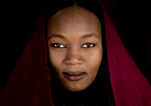 Portrait of a tuareg girl in traditionnal red clothing, Tripolitania, Ghadames, Libya