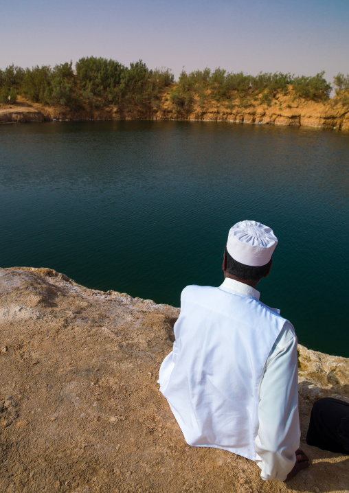 Man watching a lake in the desert, Tripolitania, Ghadames, Libya