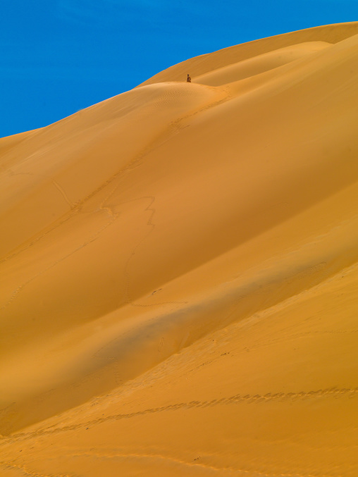 People climbing the dunes in ubari desert, Fezzan, Umm al-Maa, Libya