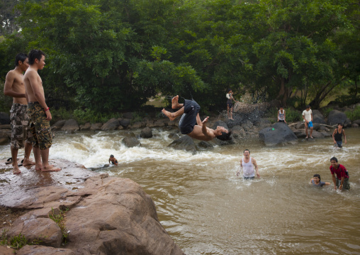 Kids jumping in tadfan waterfalls, Boloven, Laos