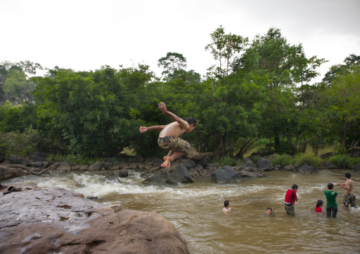 Kids jumping in tadfan waterfalls, Boloven, Laos