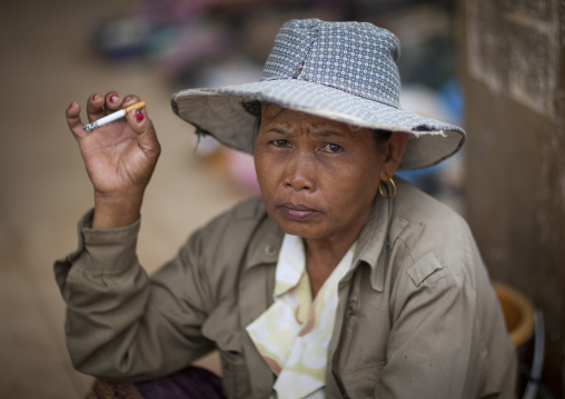 Woman smoking a cigarette, Pakse, Laos