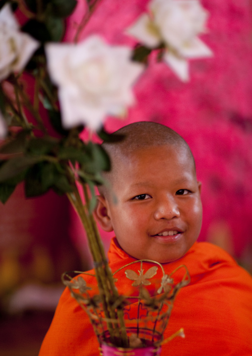 Novice buddhist monk with flowers, Nam deng, Laos