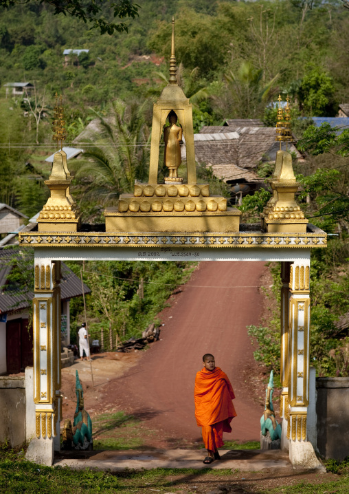 Monk at the entrance of phra saek kham temple, Muang la, Laos