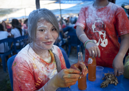 Woman with flour on the face during pii mai lao new year celebration, Luang prabang, Laos