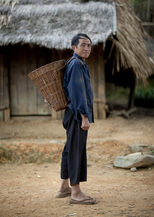 Hmong minority man carrying a basket, Luang prabang, Laos