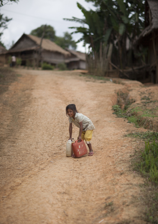 Hmong minority kid carrying water, Luang prabang, Laos