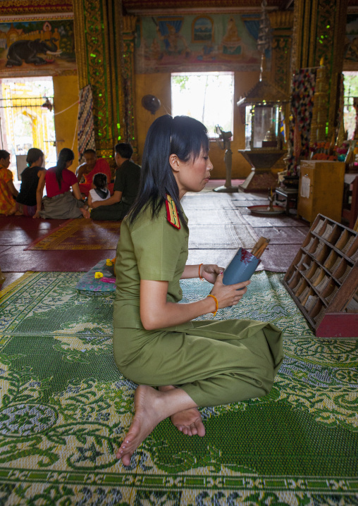 Army woamn praying in vat si muang, Vientiane, Laos