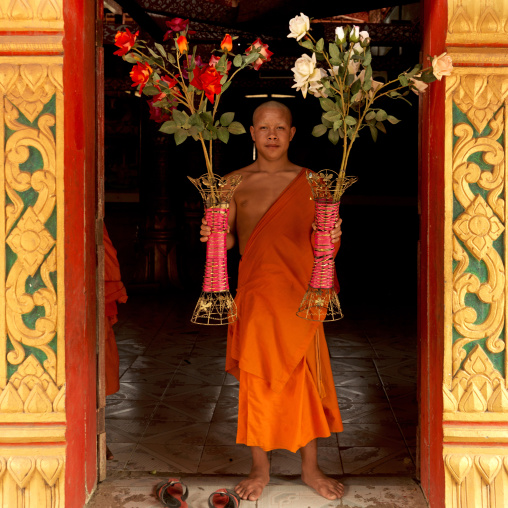Buddhist monk holding flowers, Nam deng, Laos