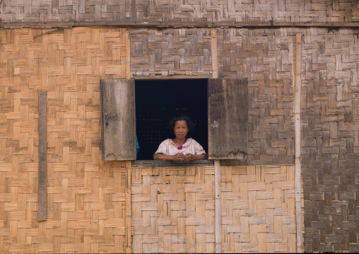 Khmu minority woman at the window of her house, Xieng khouang, Laos