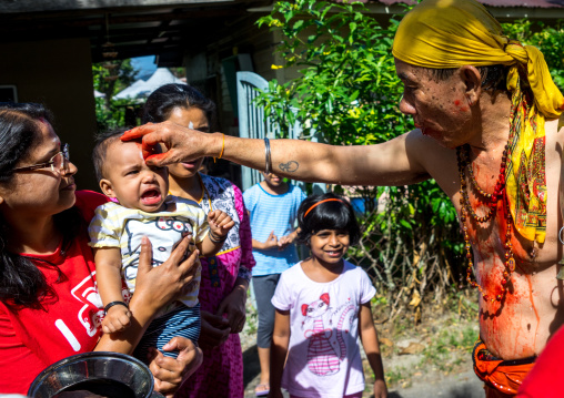 Hindu Devotee In Annual Thaipusam Religious Festival In Batu Caves Blessing A Baby, Southeast Asia, Kuala Lumpur, Malaysia