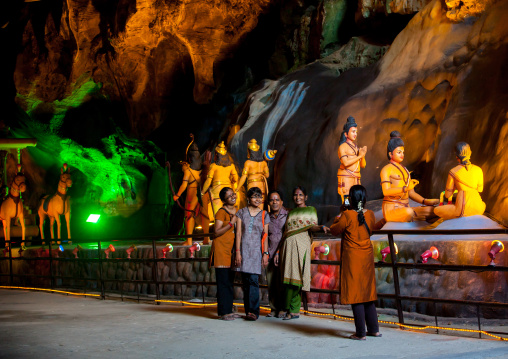 Tourists Looking At Hindu Figures In The Batu Caves, Southeast Asia, Kuala Lumpur, Malaysia