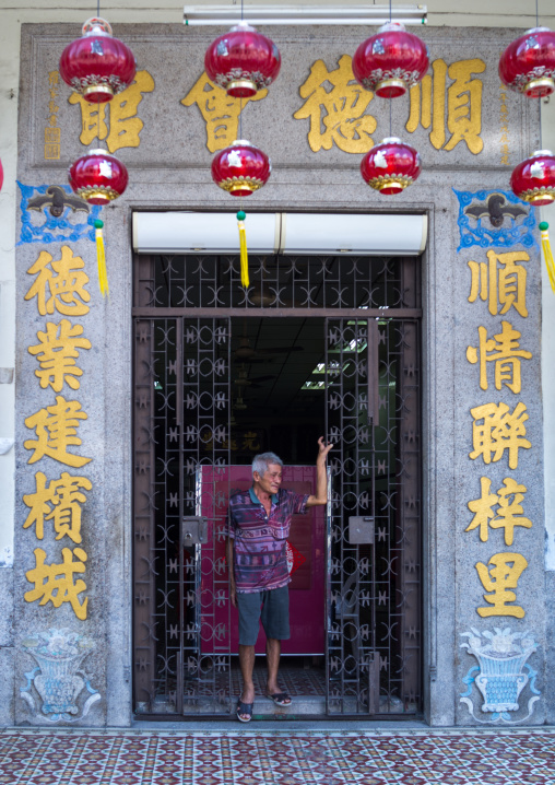 Chinese Man In The Entrance Of An Old Colonial House, Penang Island, George Town, Malaysia