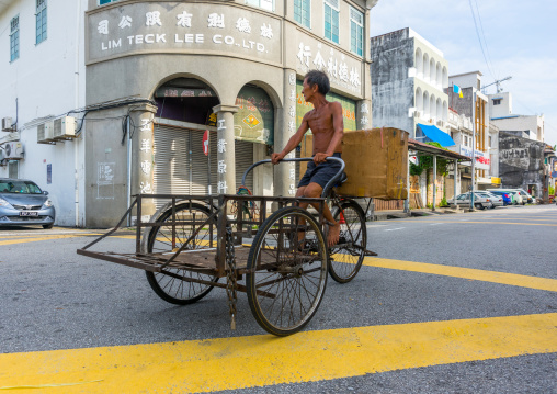 Skinny Man Rickshaw Pedalling Through Chinatown, Penang Island, George Town, Malaysia