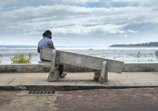 Woman In Front Of The Sea Sitting On A Broken Bench, Inhambane, Inhambane Province, Mozambique
