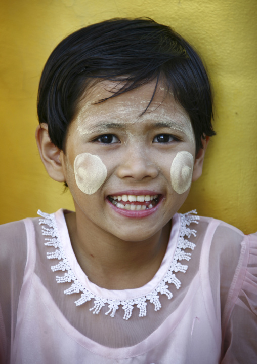 A Young Girl Smiling With Thanaka On Cheeks, Rangoon, Myanmar