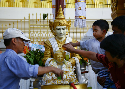 People Putting Water On A Statue In Shwedagon Pagoda, Rangoon, Myanmar