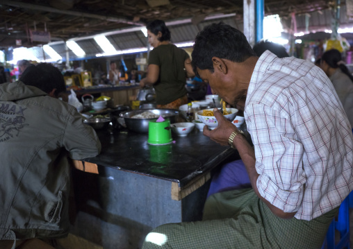 Man Eating In A Restaurant Inside A Market, Thandwe, Myanmar