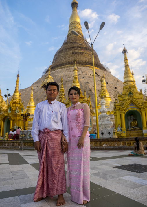 Young Couple Just Married Pausing In Front Of Shwedagon Pagoda, Rangoon, Myanmar
