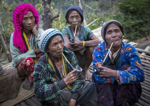 Tribal Chin Women From Muun Tribe With Tattoos On The Face Smoking, Mindat, Myanmar