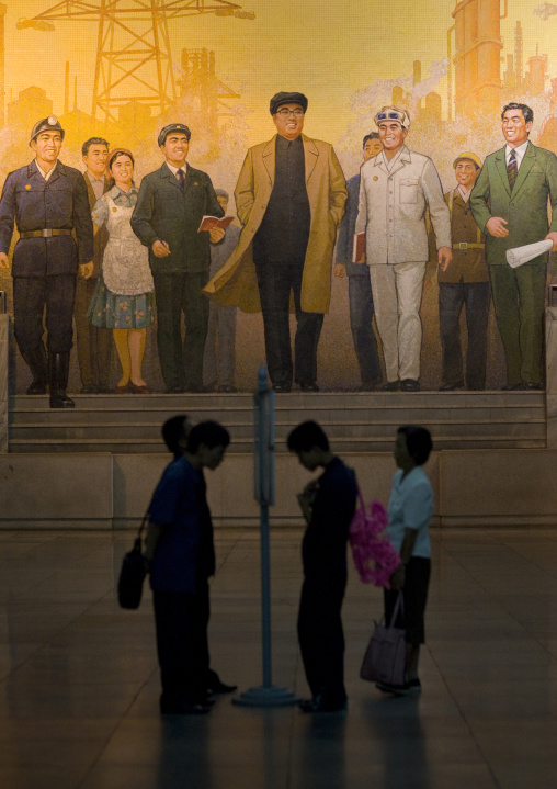 North Korean people reading the offical state newspaper in the puhung metro station, Pyongan Province, Pyongyang, North Korea