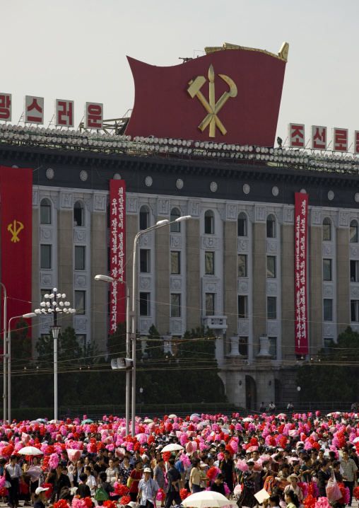 North Korean people with plastic bunches of red flowers celebrating the 60th anniversary of the regim, Pyongan Province, Pyongyang, North Korea