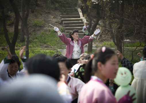 North Korean people dancing in a park for the day of the sun which is the birth anniversary of Kim Il-sung, Pyongan Province, Pyongyang, North Korea