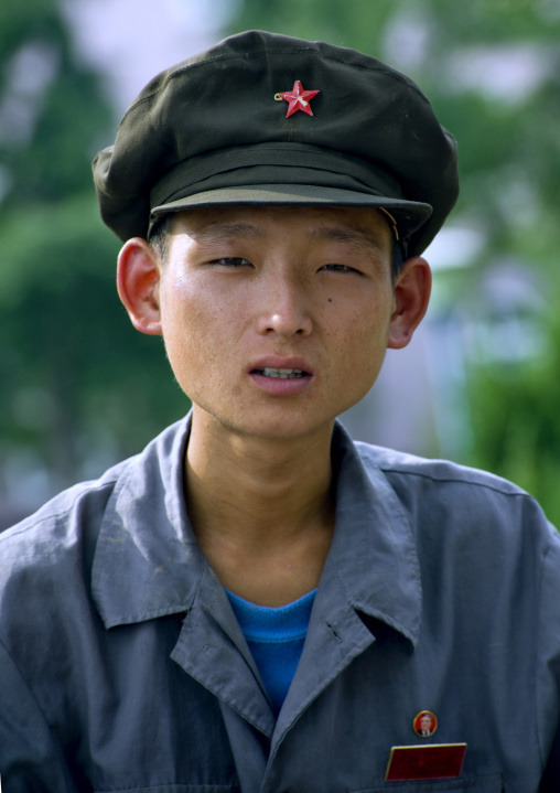 Skinny North Korean young man with a cap, Pyongan Province, Pyongyang, North Korea