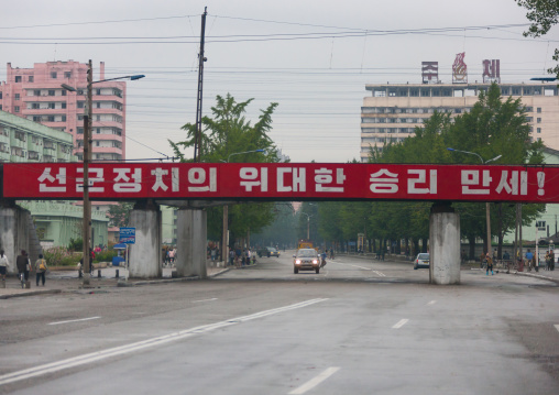 Red propaganda billboard over a road saying long live the great songun political victory!, South Hamgyong Province, Hamhung, North Korea