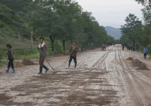 North Korean workers repairing muddy roads in the countryside, North Hamgyong Province, Jung Pyong Ri, North Korea