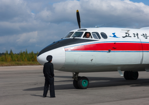 North Korean employee in front of an air Koryo domestic plane on Samjiyon airport, Ryanggang Province, Samjiyon, North Korea