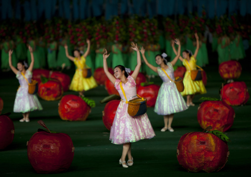 Women dancing between apples at Arirang mass games in may day stadium, Pyongan Province, Pyongyang, North Korea