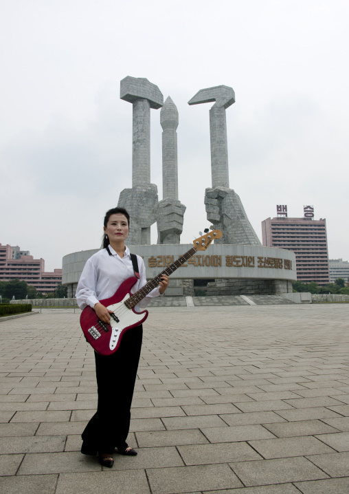 North Korean state artist bassist on national day in front of the monument to the founding of the Party, Pyongan Province, Pyongyang, North Korea