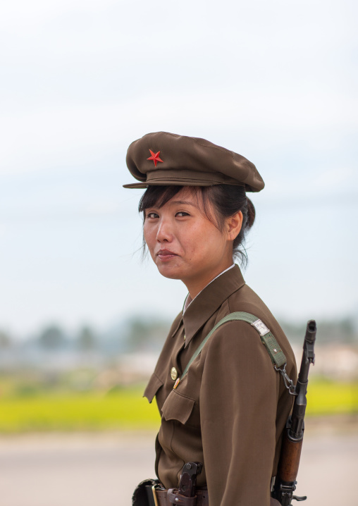 North Korean female solidier with rifle in Pyongyang film studio, Pyongan Province, Pyongyang, North Korea