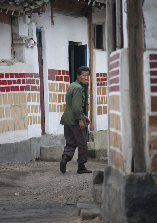 North Korean man passing through a narrow street in the old town, North Hwanghae Province, Kaesong, North Korea