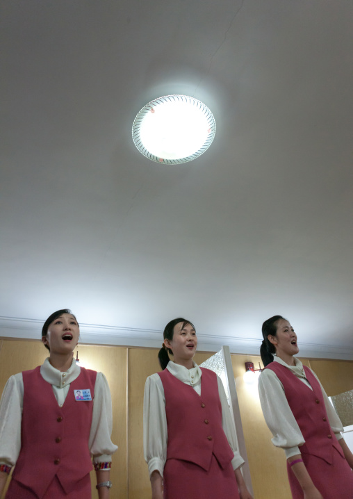 North Korean waitresses singing in a restaurant, Pyongan Province, Pyongyang, North Korea