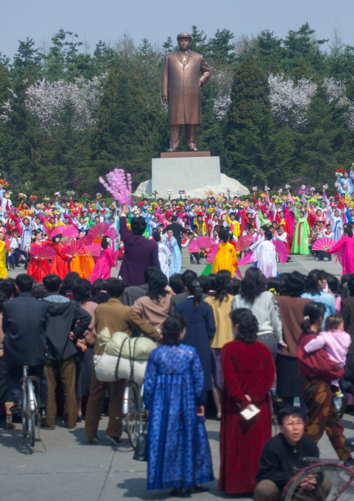 North Korean women dancing in front of Kim il Sung statue in a village, South Pyongan Province, Nampo, North Korea
