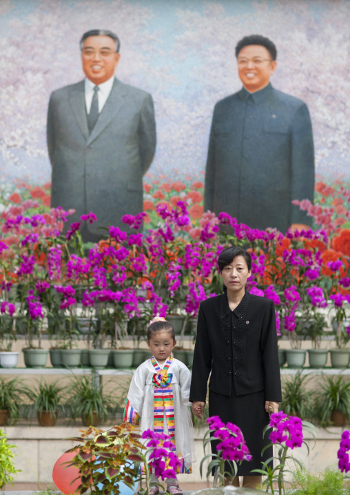 Mother and daughter posing in the international Kimilsungia and Kimjongilia festival, Pyongyang District, Pyongyang, North Korea