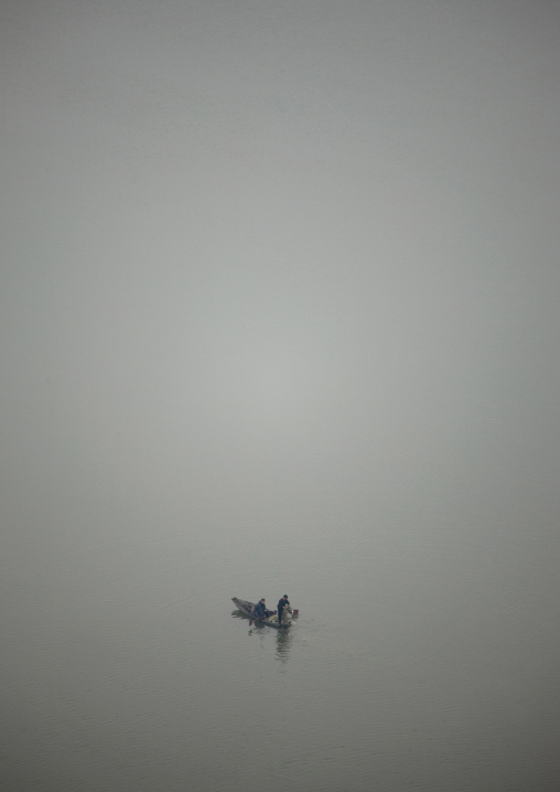 Two men fishing on a boat on Taedong river, Pyongan Province, Pyongyang, North Korea