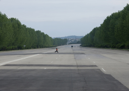 North Korean child crossing an empty highway, South Pyongan Province, Nampo, North Korea